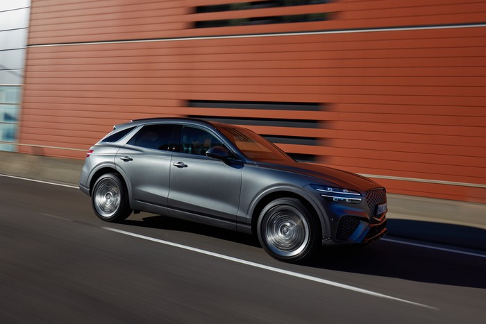 Grey Genesis GV70 SUV in motion