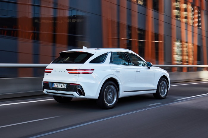 White Genesis GV70 2.5T SUV driving on a road
