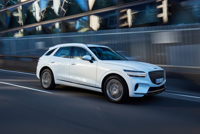 White Genesis GV70 2.5T SUV in motion