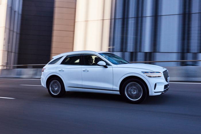 White Genesis GV70 SUV in motion