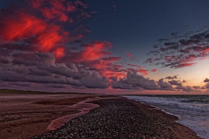 Red Clouds Over Beach at Sunset