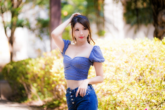 Brunette Asian Model Posing Outdoors with Blurred Background