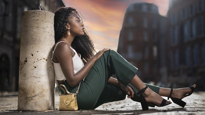 Model with Black Hair Sitting Outdoors 4K