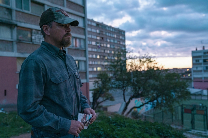 Matt Damon in Stillwater, urban scene at dusk