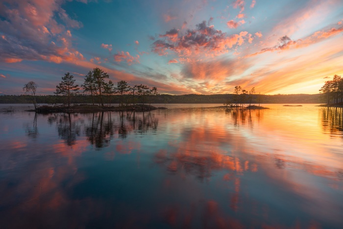 Vibrant Sunset Reflection over Lake with Islands