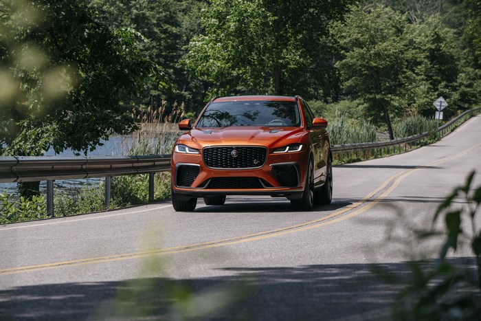 Orange Jaguar F-Pace SVR SUV on a scenic road
