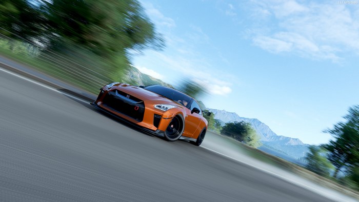 Orange Nissan GT-R 2017 speeding on a mountain road