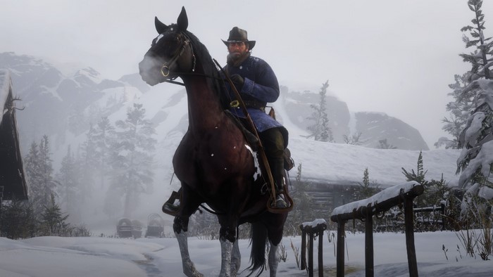 Arthur Morgan on horseback in a snowy mountain landscape