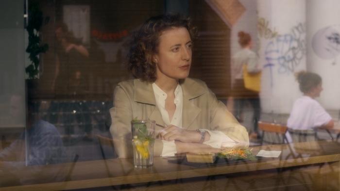 Maren Eggert in Im Your Man, pensive at cafe table