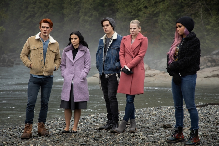 Riverdale characters standing by a river