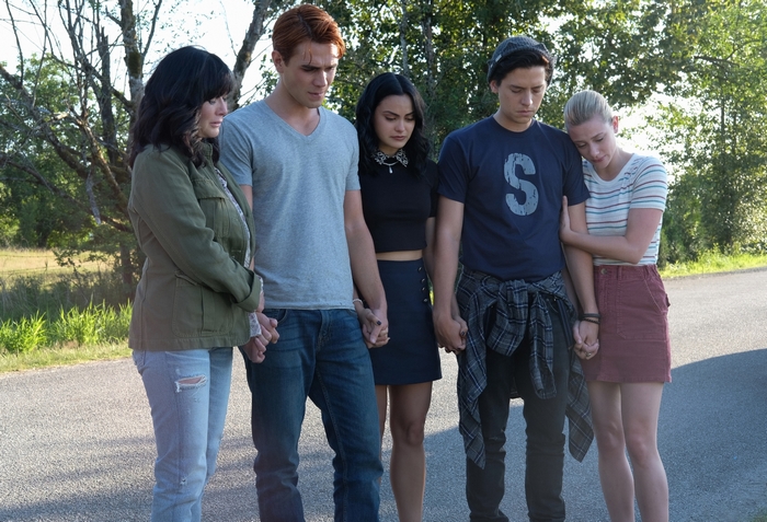 Riverdale cast holding hands solemnly