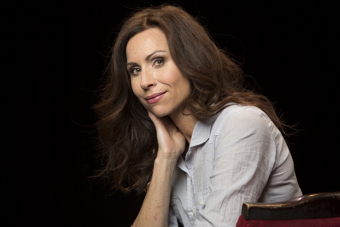 Minnie Driver smiling in a casual portrait