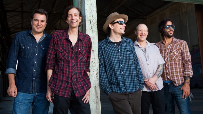 The Wallflowers band members posing outdoors