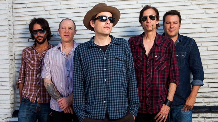 The Wallflowers band members posing outdoors