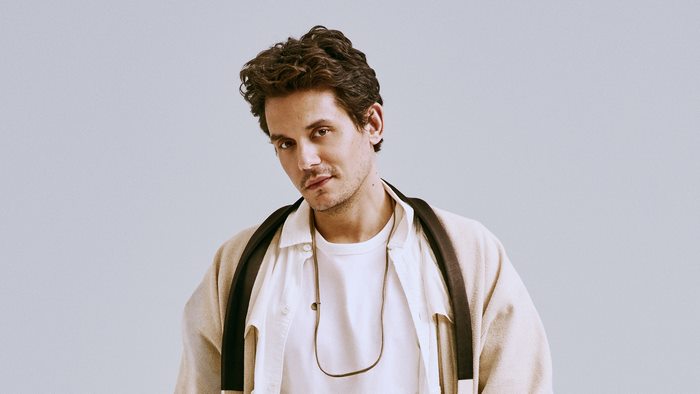 John Mayer looking at camera in light jacket