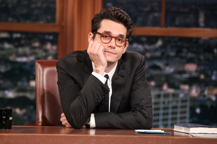 John Mayer in suit and glasses on a talk show