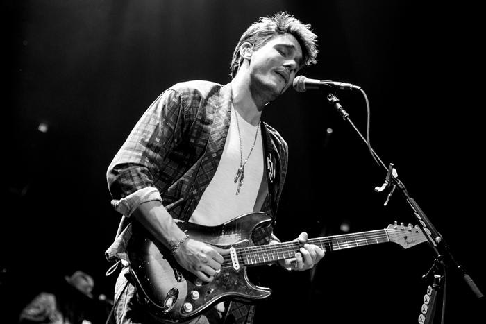 John Mayer singing and playing guitar on stage