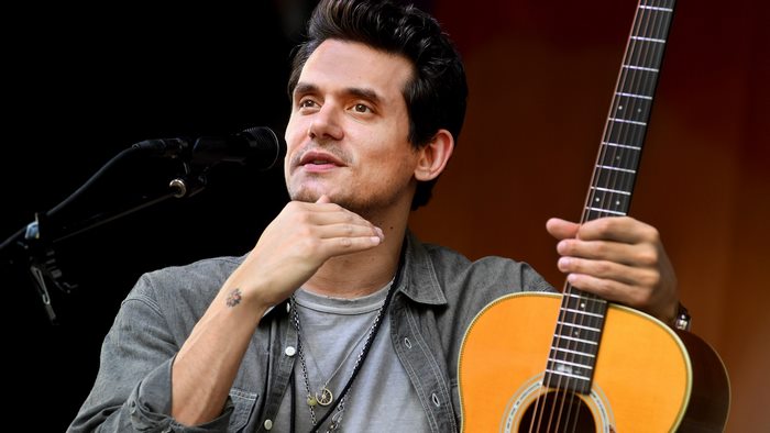 John Mayer singing and playing acoustic guitar