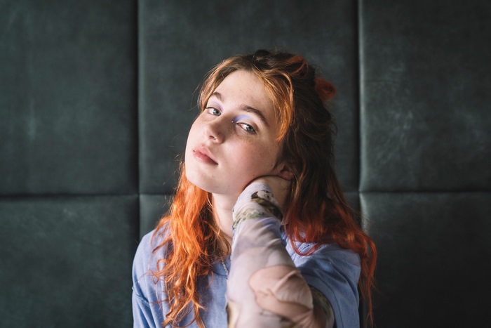 Clairo's close-up portrait with orange hair