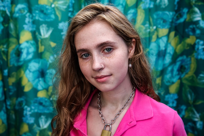 Clairo portrait with freckles and padlock necklace