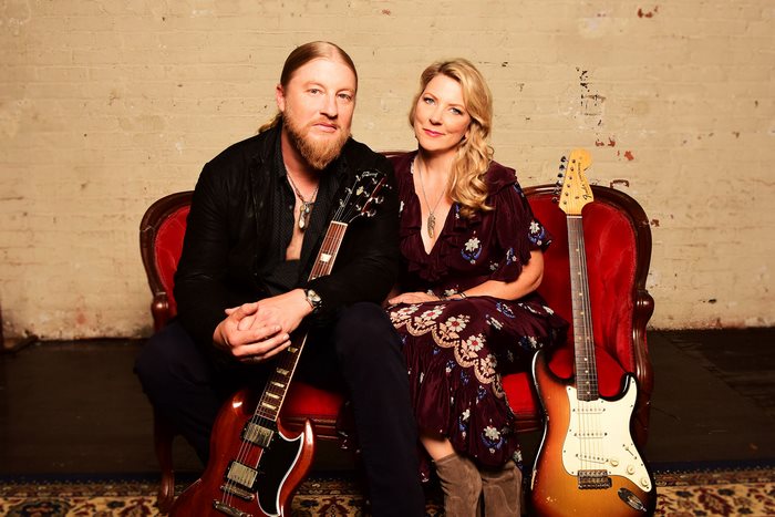 Tedeschi Trucks Band sitting with guitars