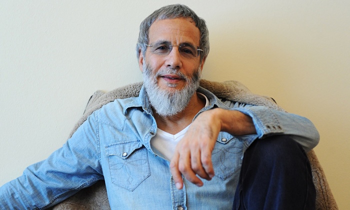 Cat Stevens smiling with grey beard and glasses