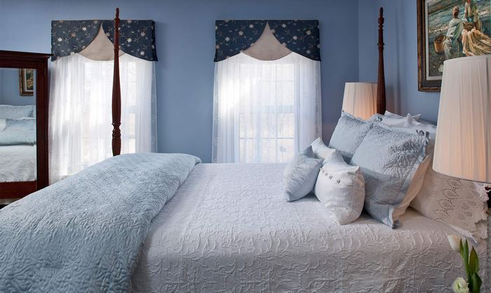 Elegant blue bedroom with a four-poster bed