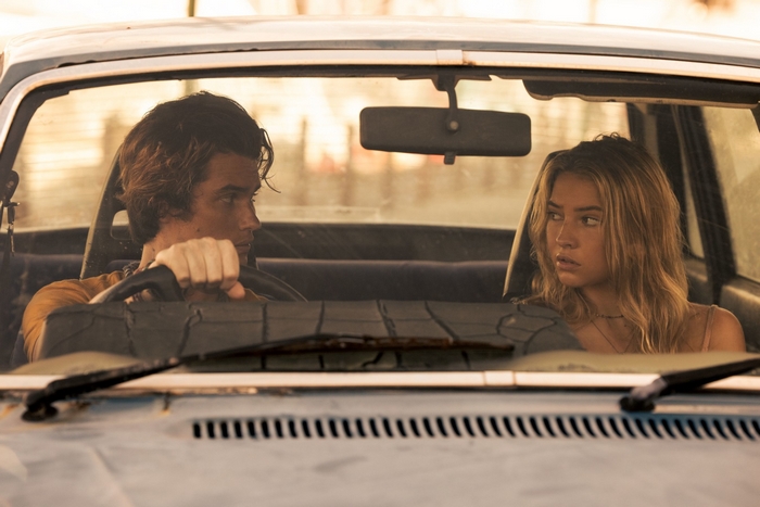 Chase Stokes and Madelyn Cline in car