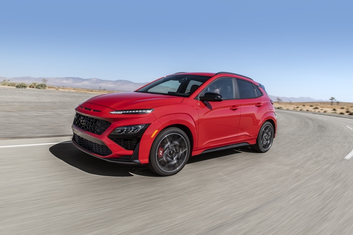 Red 2022 Hyundai Kona N SUV driving on desert road