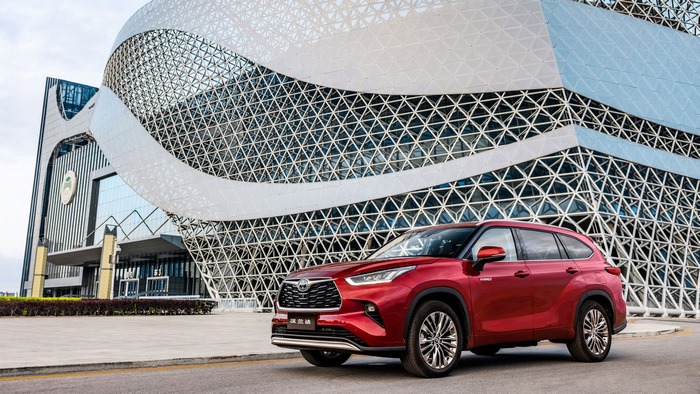 Red Toyota Highlander Hybrid SUV and modern architecture