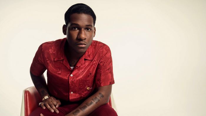 Leon Bridges posing in a red shirt