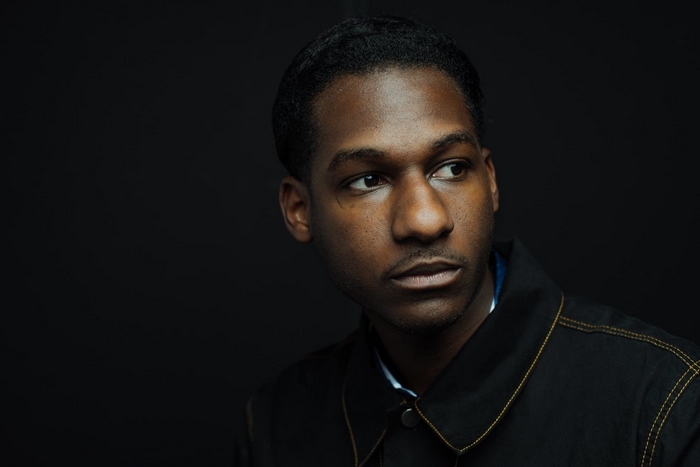 Portrait of Leon Bridges against a dark background