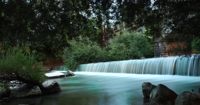 Beautiful Waterfall and River with Stone Bridge in Nature