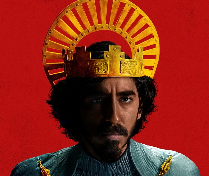 Dev Patel with golden crown and halo in The Green Knight