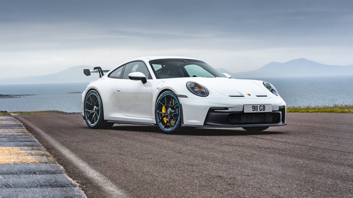 White Porsche 911 GT3 on a coastal road 4K