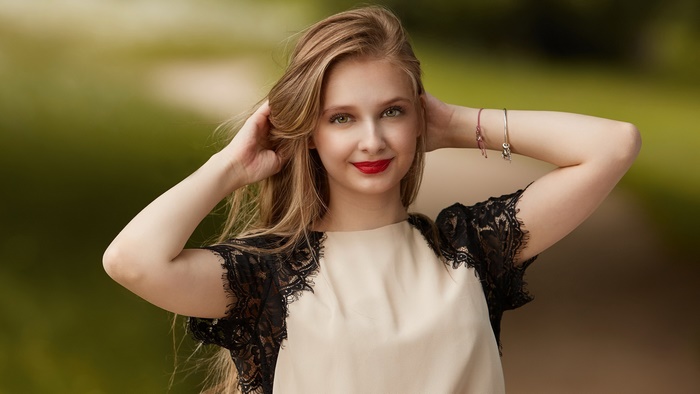 Smiling blonde model with red lipstick