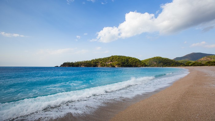 Beautiful turquoise beach with green hills