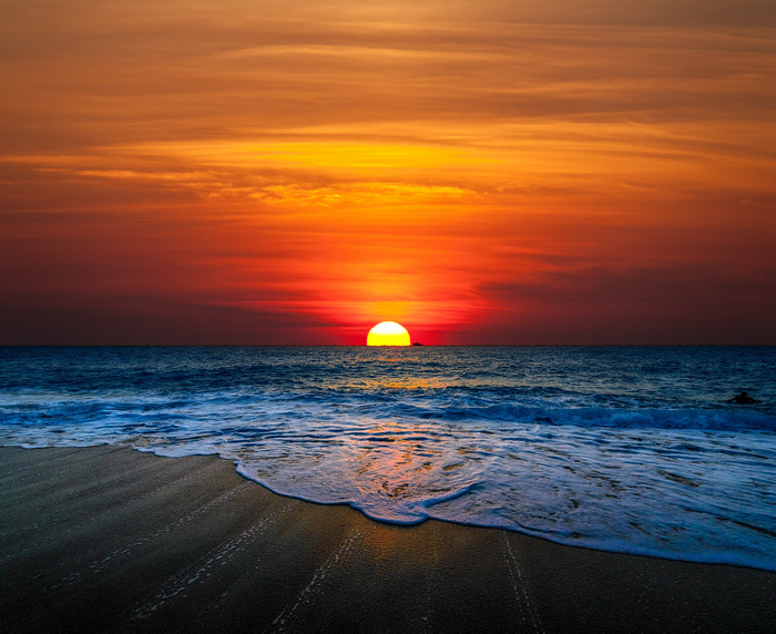 Vibrant Sunset over Ocean and Beach