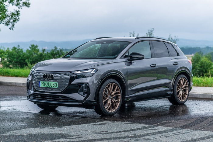 Grey Audi Q4 e-tron electric SUV on wet road