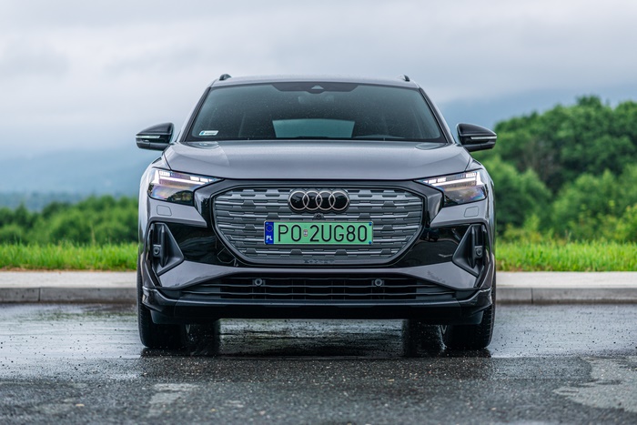 Front view of Audi Q4 e-tron SUV on wet asphalt