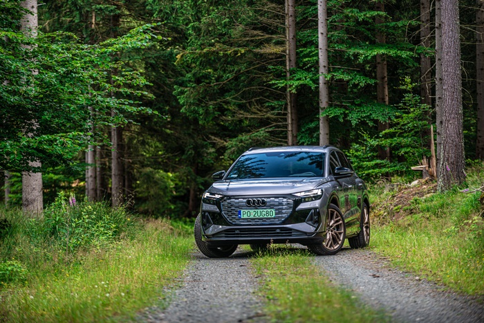 Audi Q4 e-tron electric SUV on a forest path