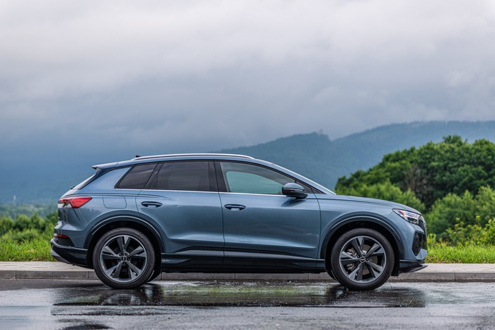Blue Audi Q4 Electric SUV side profile on wet road