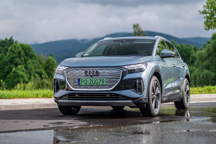 Audi Q4 E-tron electric SUV on a wet road
