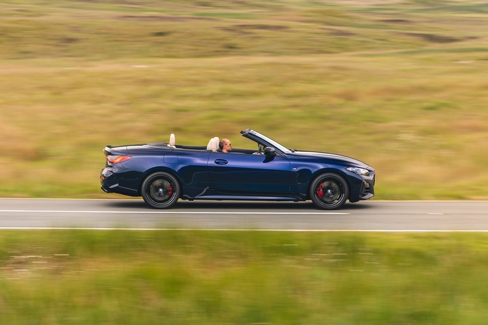 Dark blue BMW M440i Cabriolet in motion