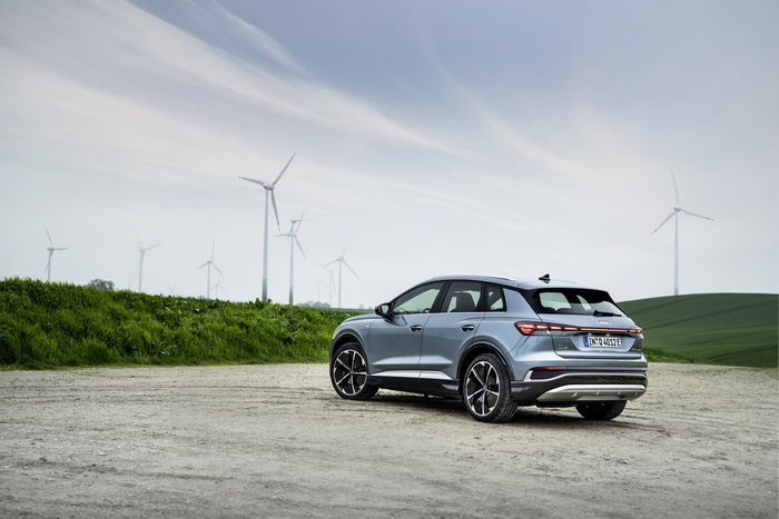 Audi Q4 e-tron S line SUV and wind farm
