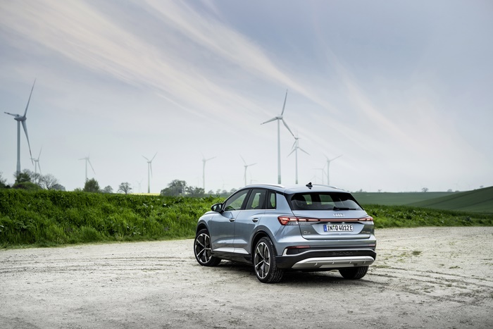 Audi Q4 e-tron electric SUV with wind turbines
