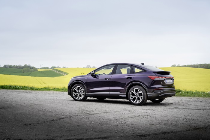 Purple Audi Q4 Sportback e-tron SUV by yellow field