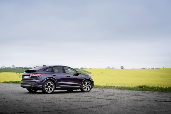 Purple Audi Q4 Sportback e-tron electric SUV by yellow field