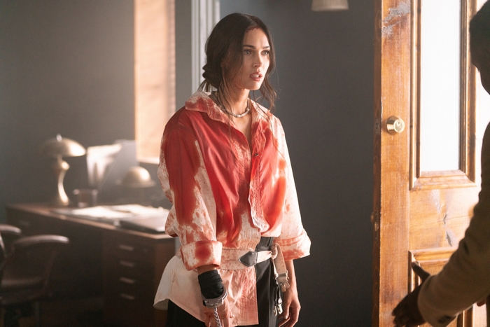 Distressed Megan Fox in bloody shirt and handcuffs