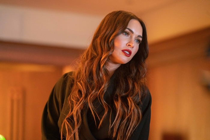 Megan Fox with long wavy hair and red lipstick